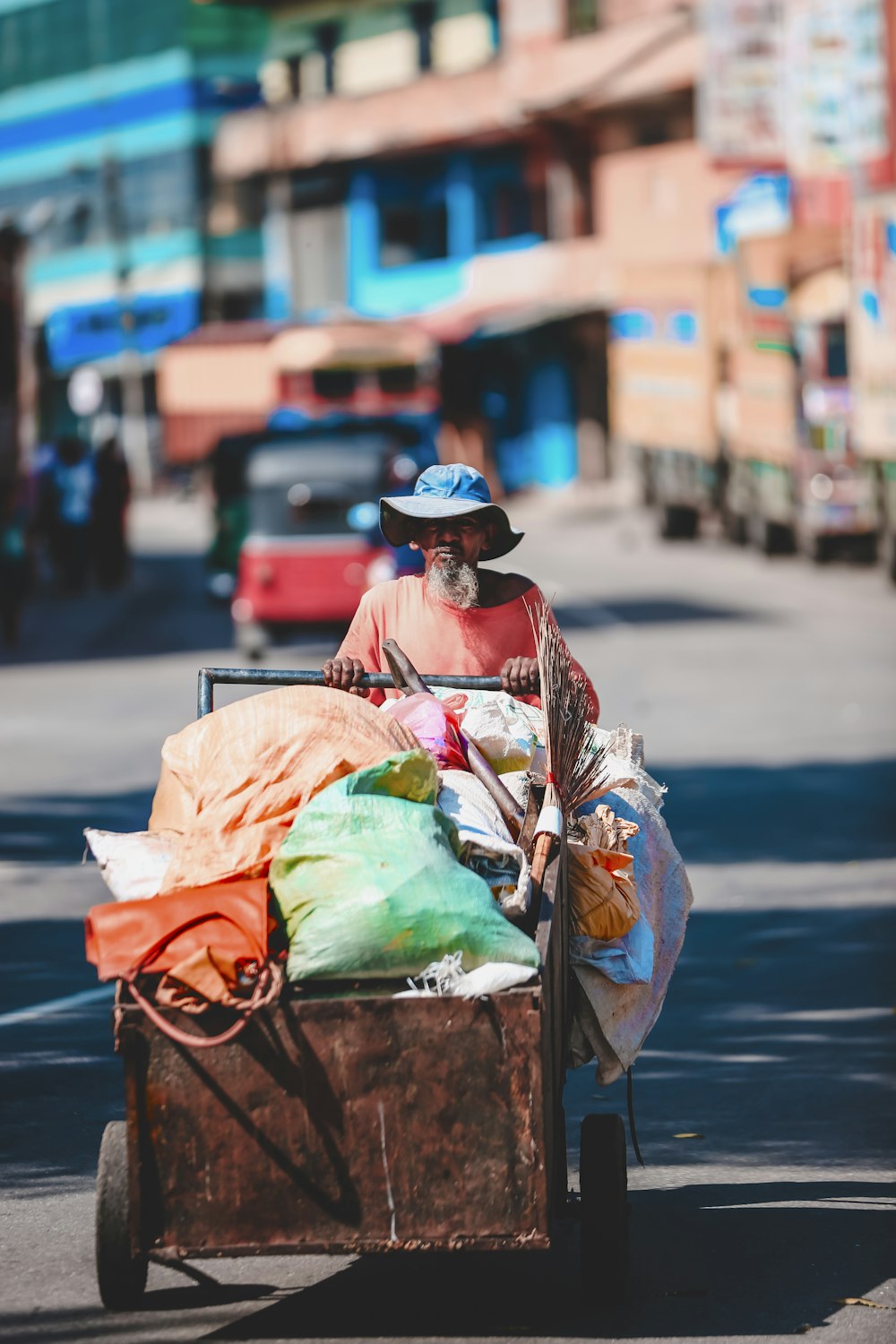 man pushing cart with sacks