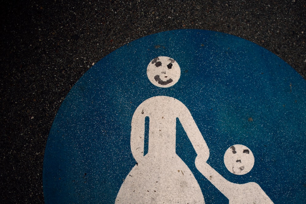 woman holding hands of child art