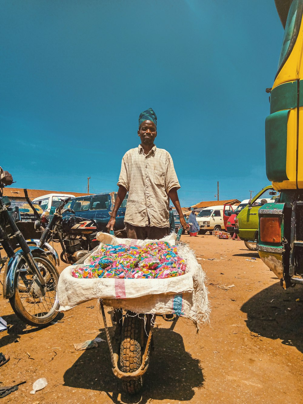 man holding wheelbarrow