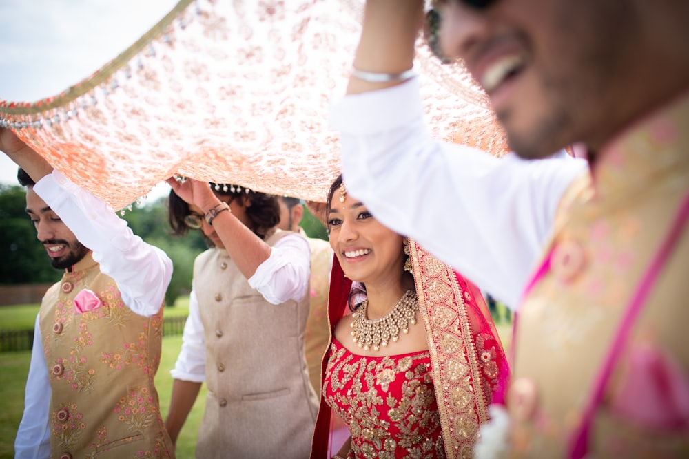 shallow focus photo of woman in red sari dress