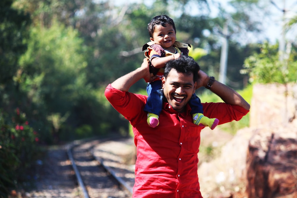 man carrying man on his shoulder