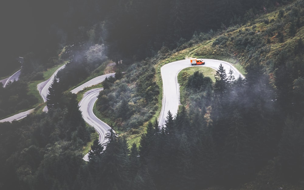 red vehicle on a winding road