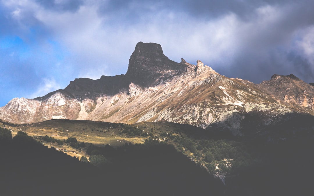 snow covered mountain under cloudy sky during daytime