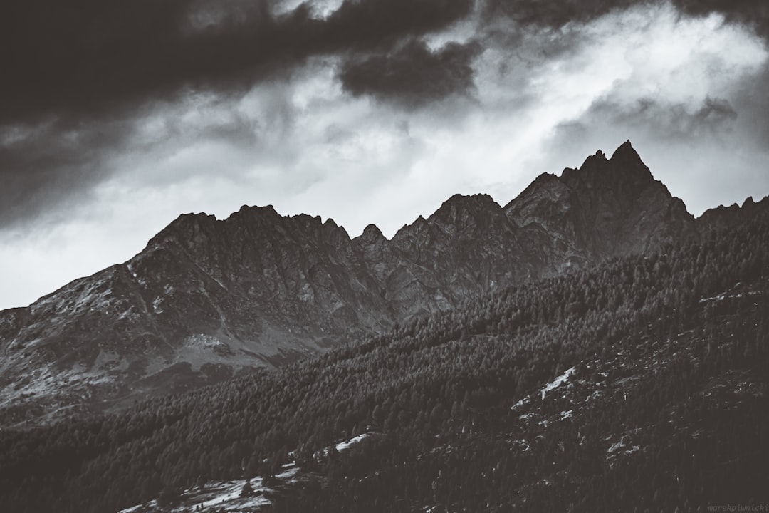 snow covered mountain under cloudy sky during daytime