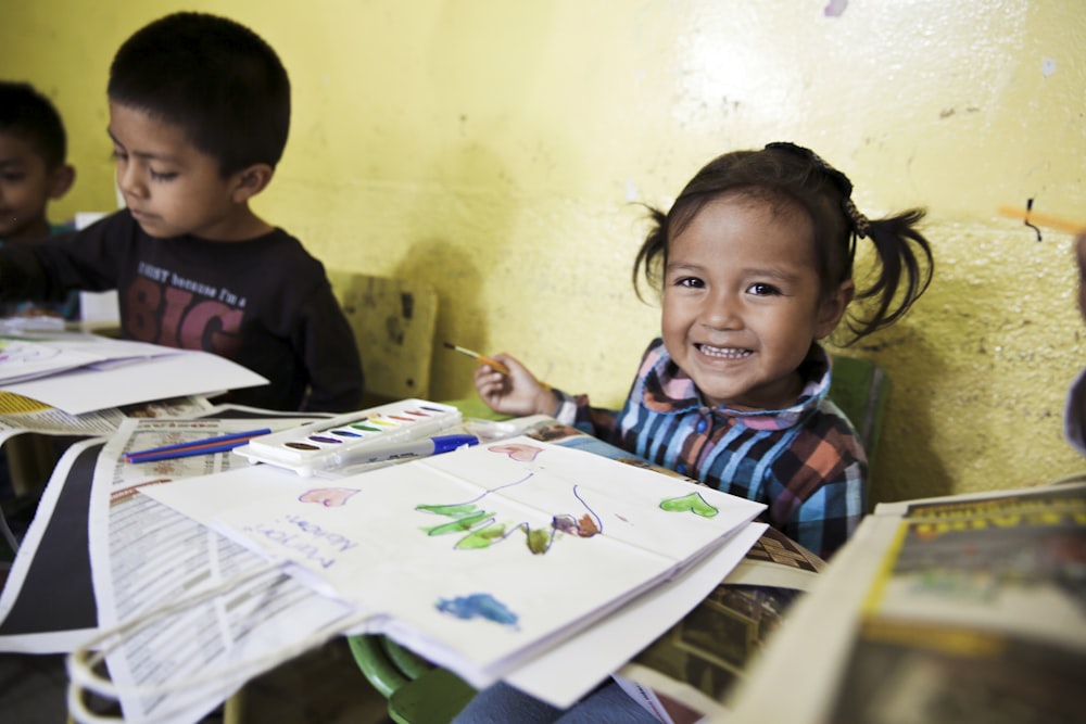 girl smiling beside printer paper