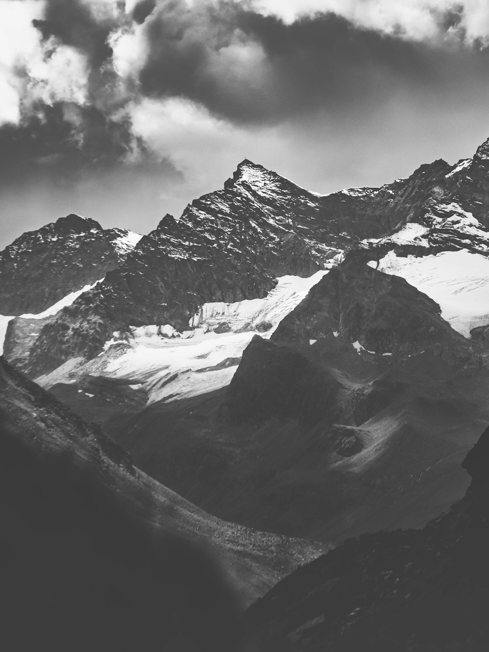 grayscale photography of mountains with snow