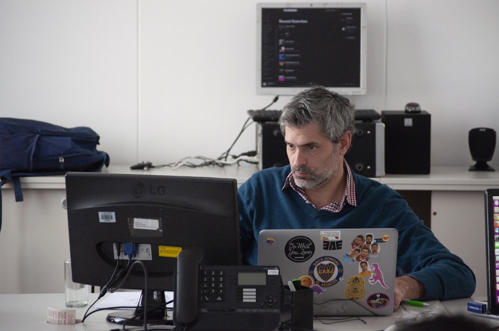 man sitting beside desk