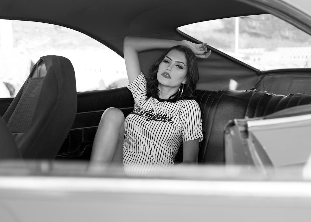 grayscale photography of woman inside car