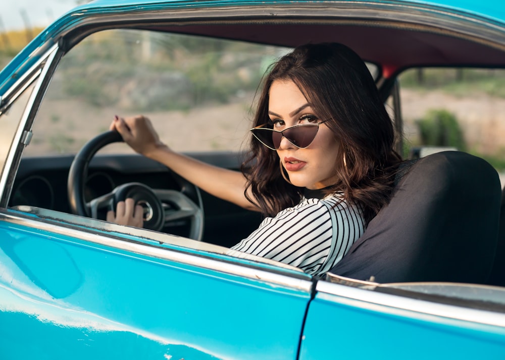 青い車を運転する女性のセレクティブフォーカス写真