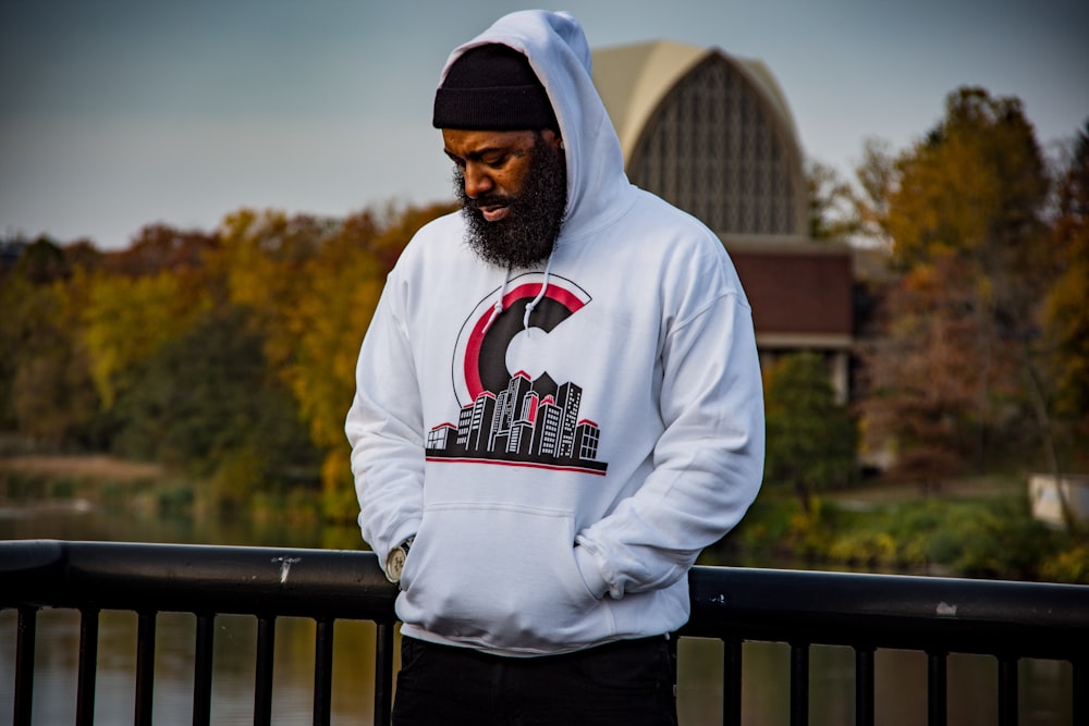 selective focus photography of standing man wearing gray pullover hoodie