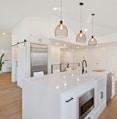 turned on pendant lamps above kitchen island