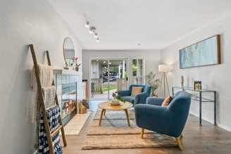 A cozy living room featuring a chic coffee table and armchairs.