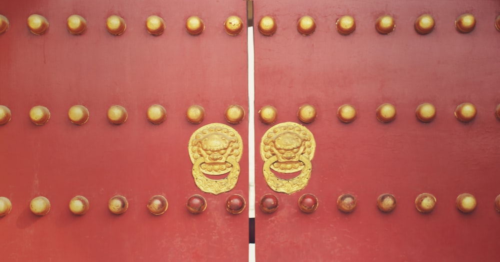 a red door with gold decorations on it