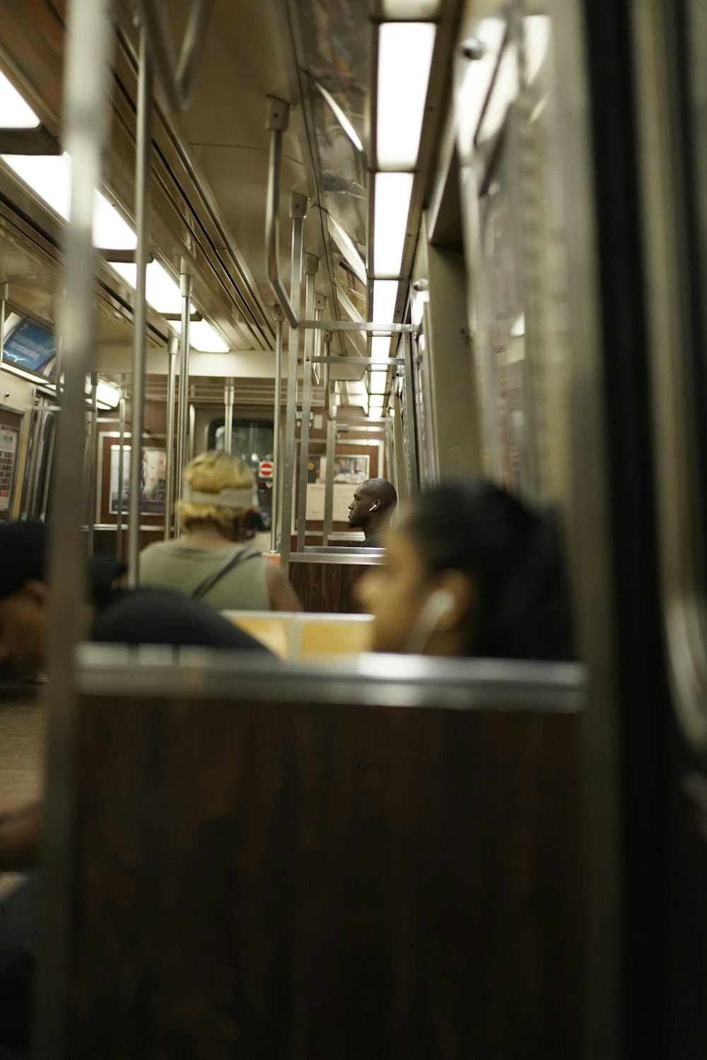 selective focus photography of people riding train