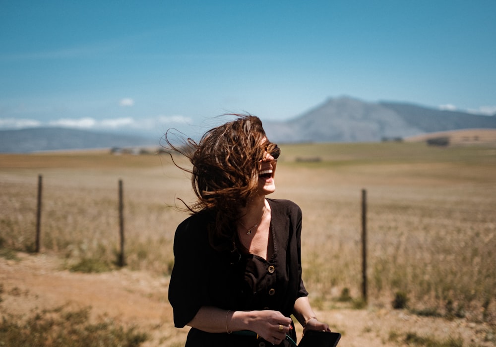 smiling woman on brown and green field