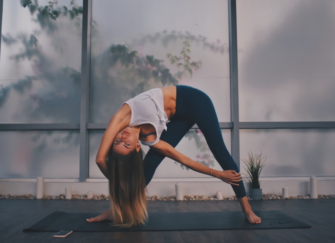 woman wearing black leggings doing yoga