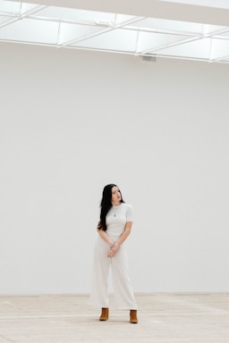 negative space for photo composition,how to photograph malmö art museum.; woman standing in front of white wall