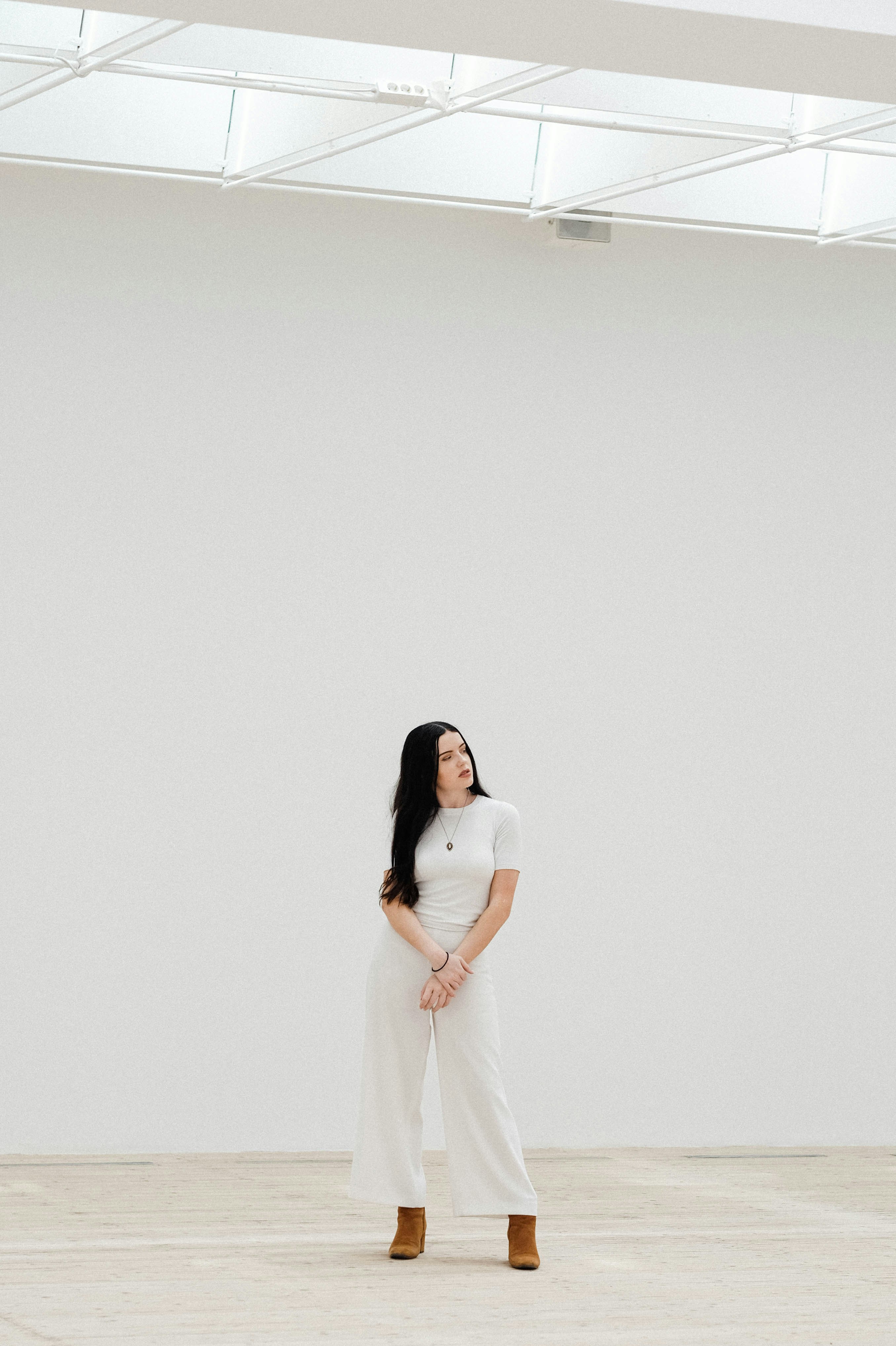 great photo recipe,how to photograph malmö art museum.; woman standing in front of white wall