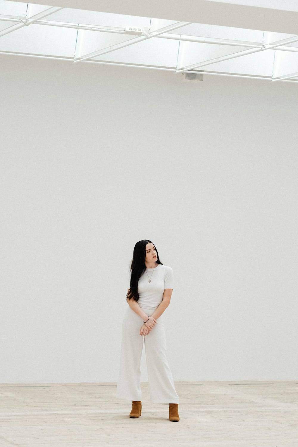 woman standing in front of white wall