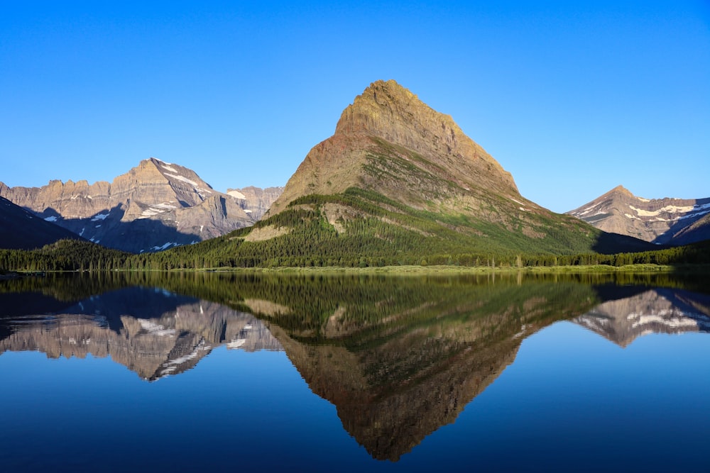 reflections of mountain on water