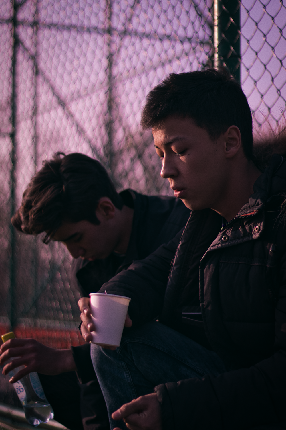 two men holding white cup