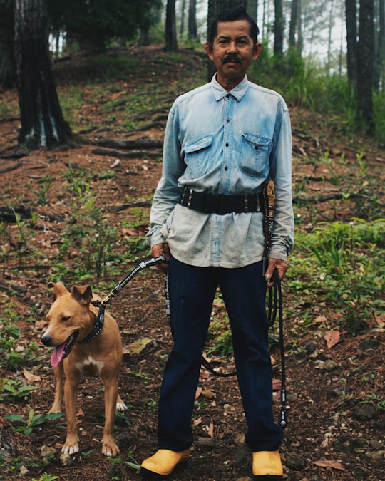 man holding dog in West Sumatra Indonesia