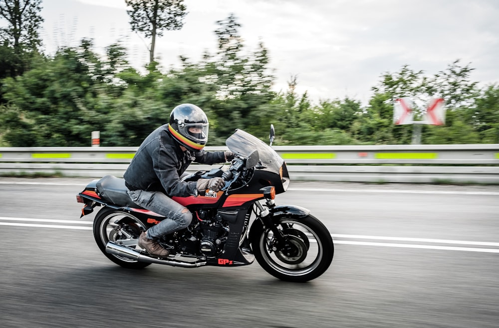 shallow focus photo of person riding sports motorcycle