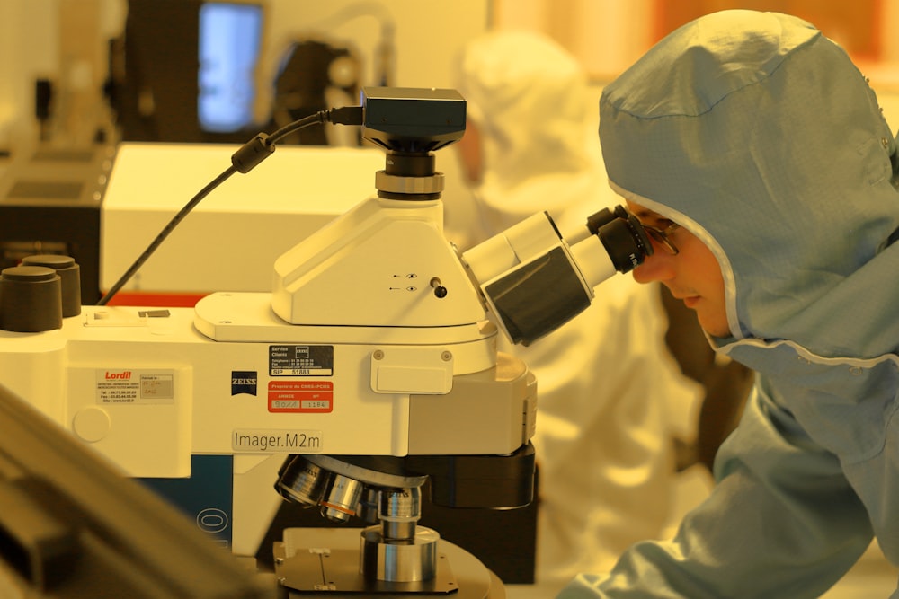 man using microscope