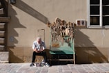 Artisan carving wooden sculptures in a workshop environment.
