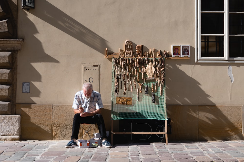 man sitting beside stand