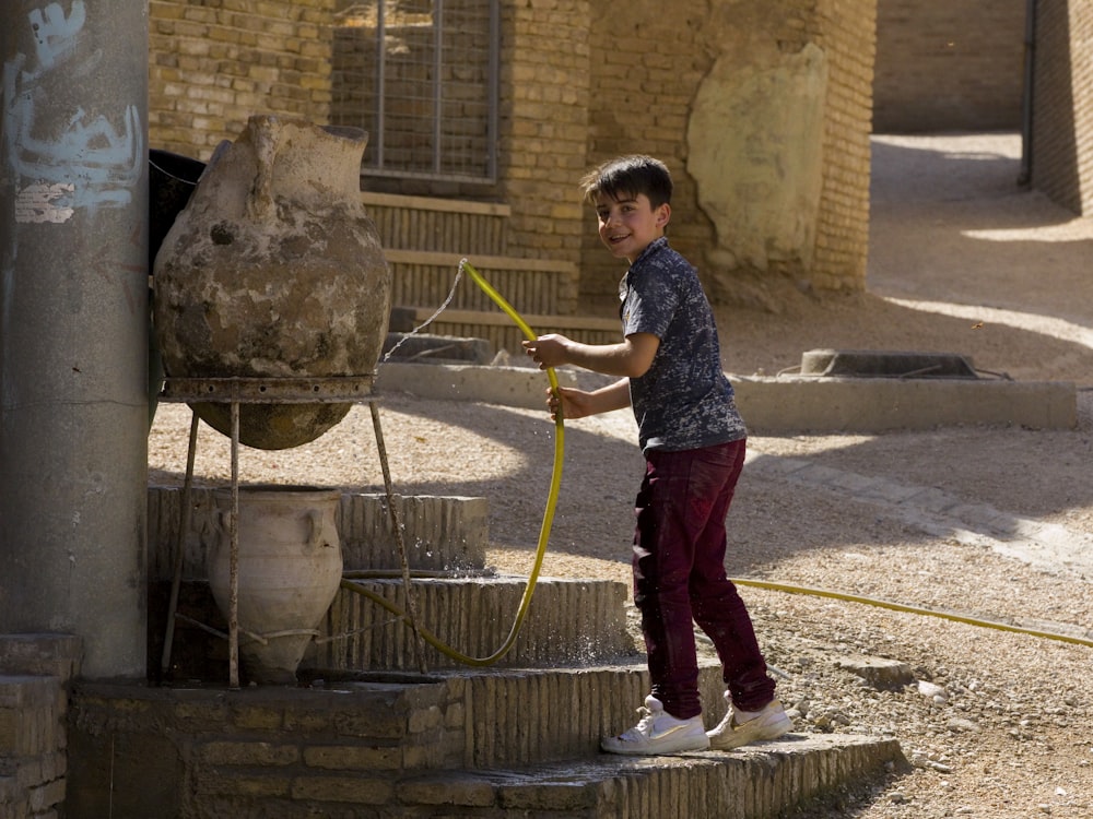 boy holding hose