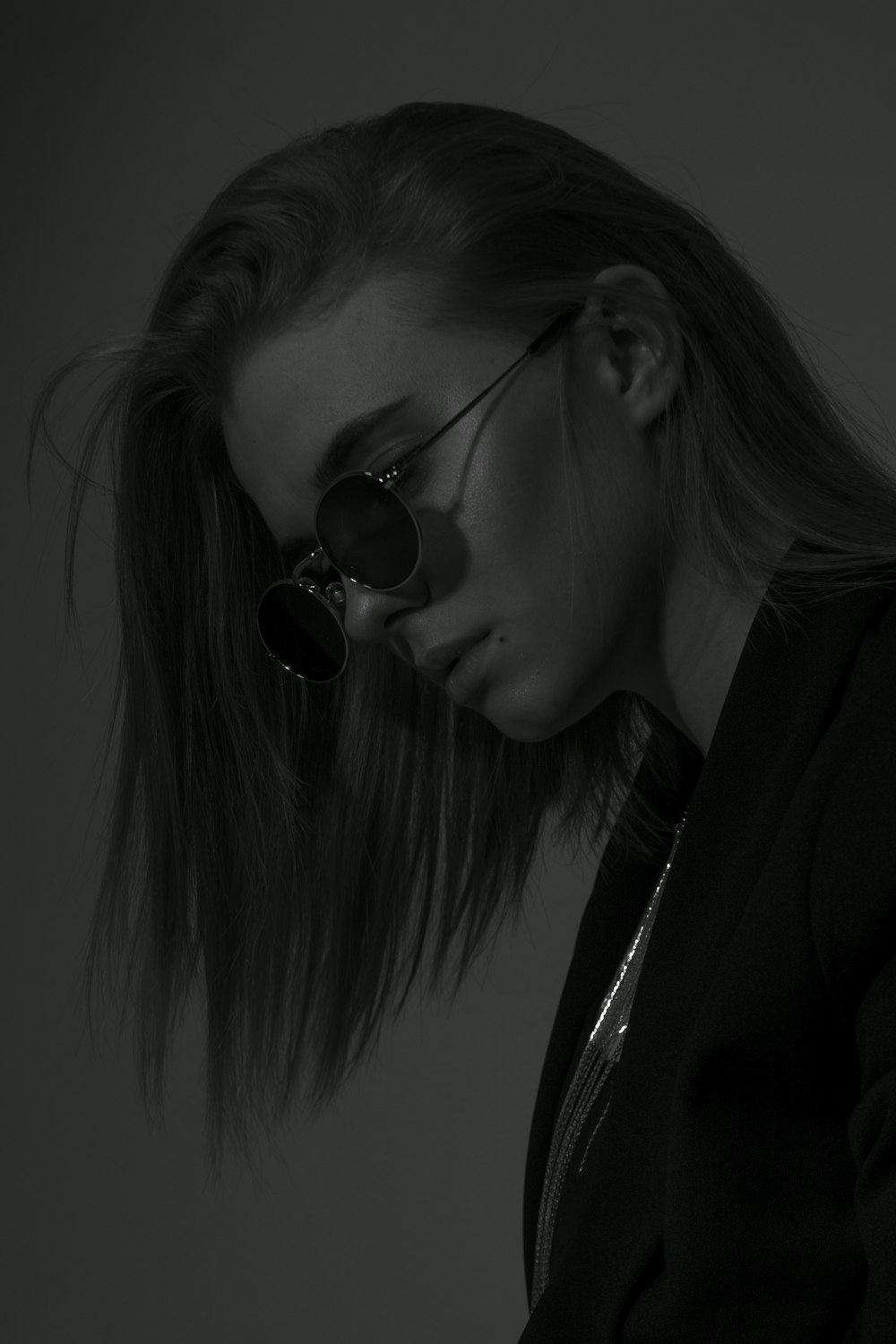 greyscale photo of woman in sunglasses