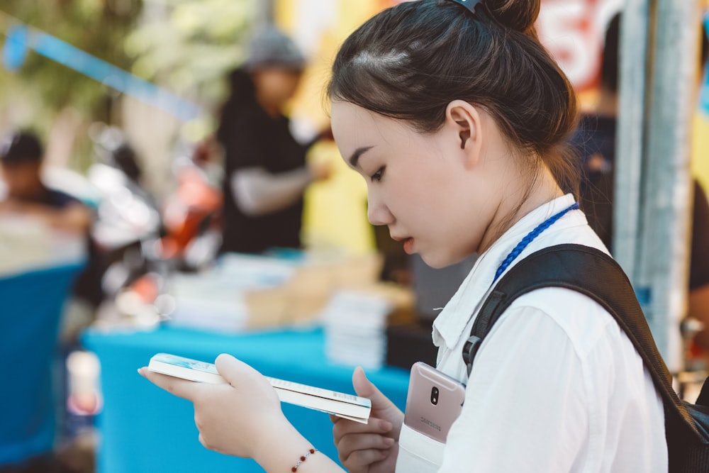 woman facing to the side while reading book