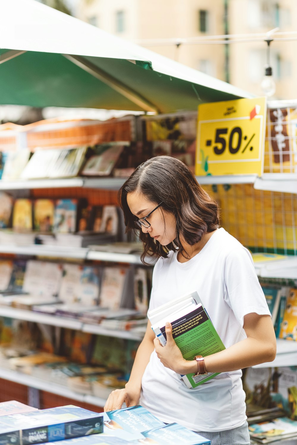 woman scanning through displayed books