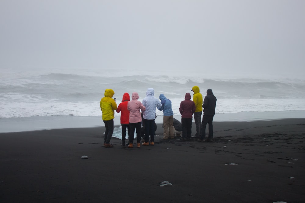 unknown persons standing near body of water