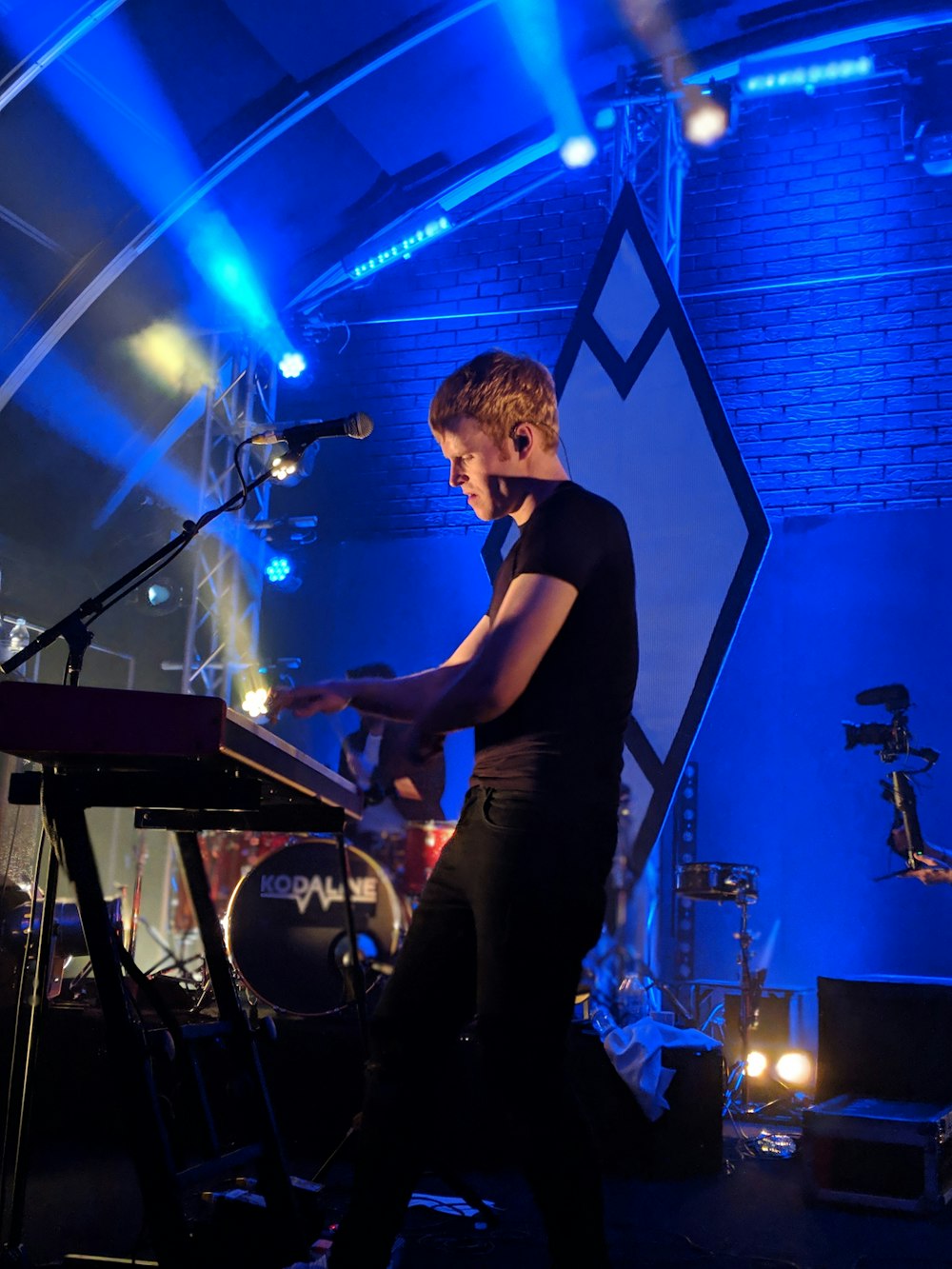 man standing near electronic piano