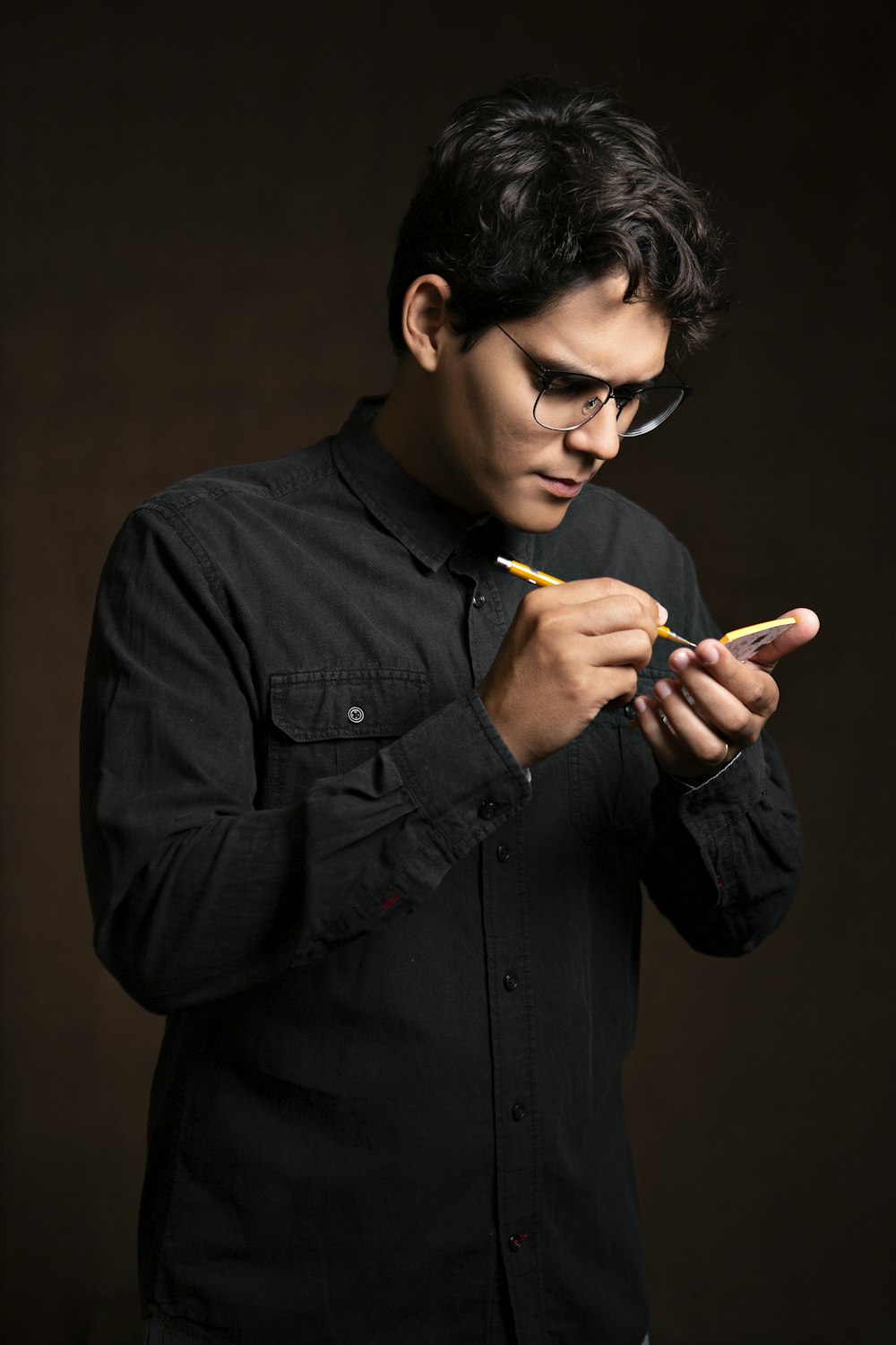 man writing on smartphone using stylus pen