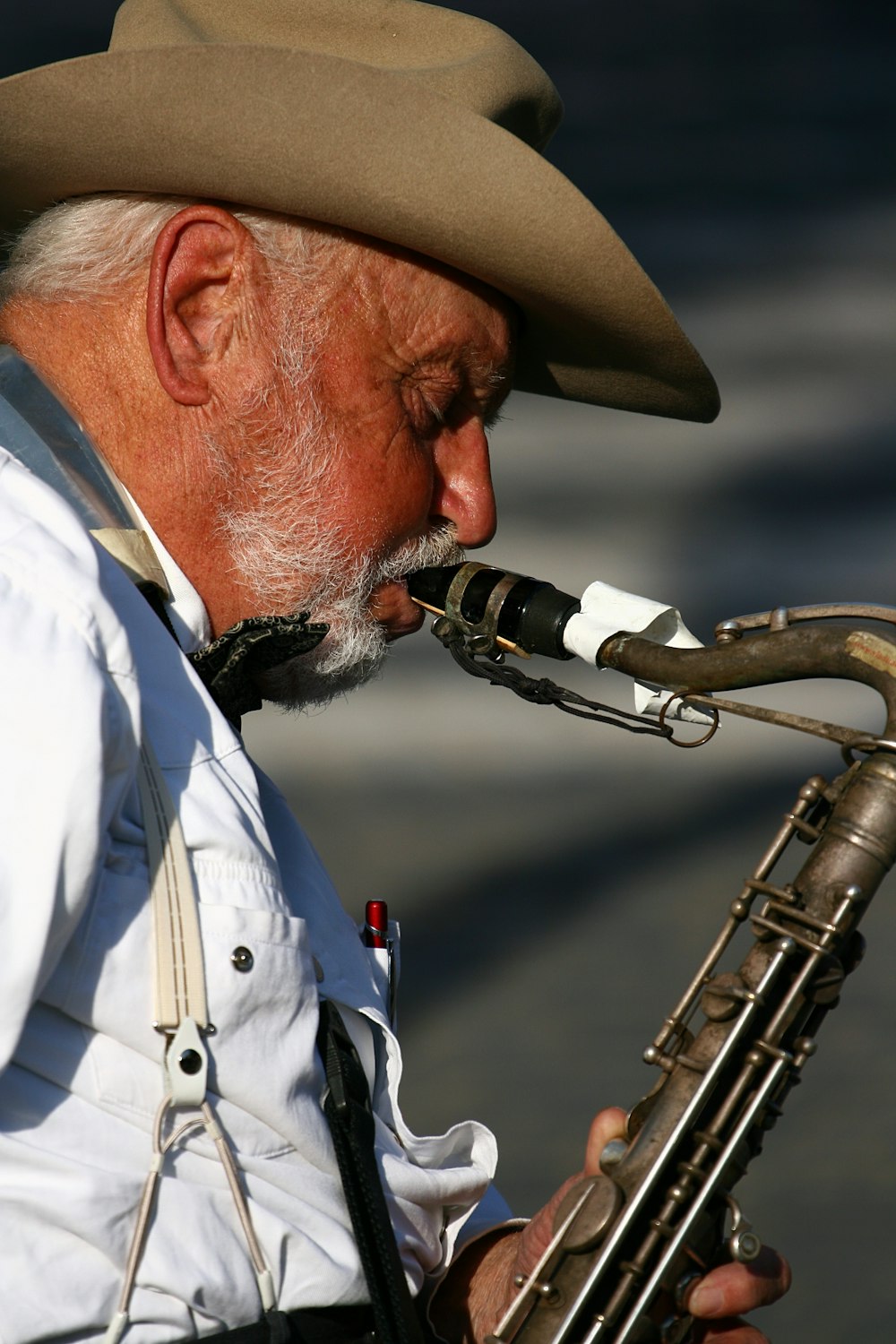 man plays wind instrument