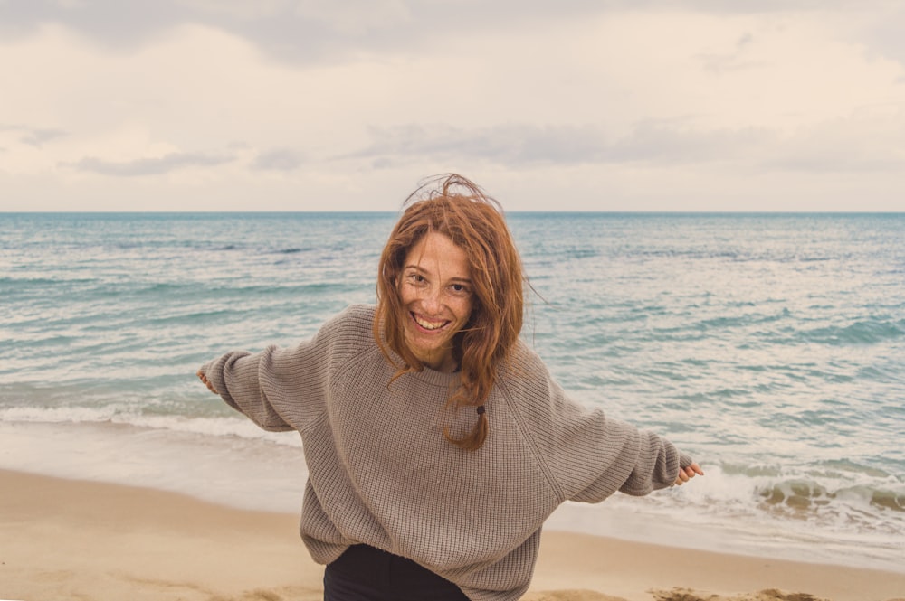 smiling woman wearing grey sweater