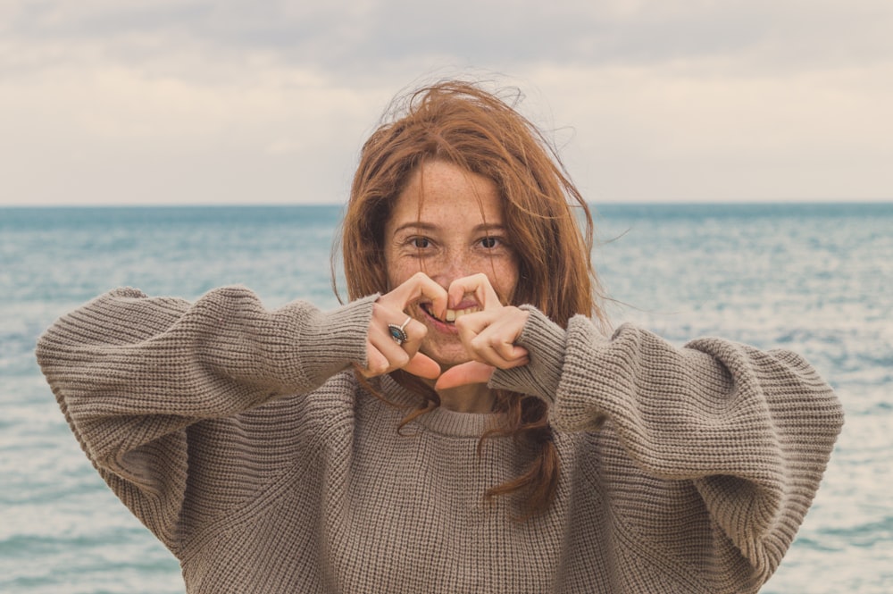 smiling woman wearing grey sweater