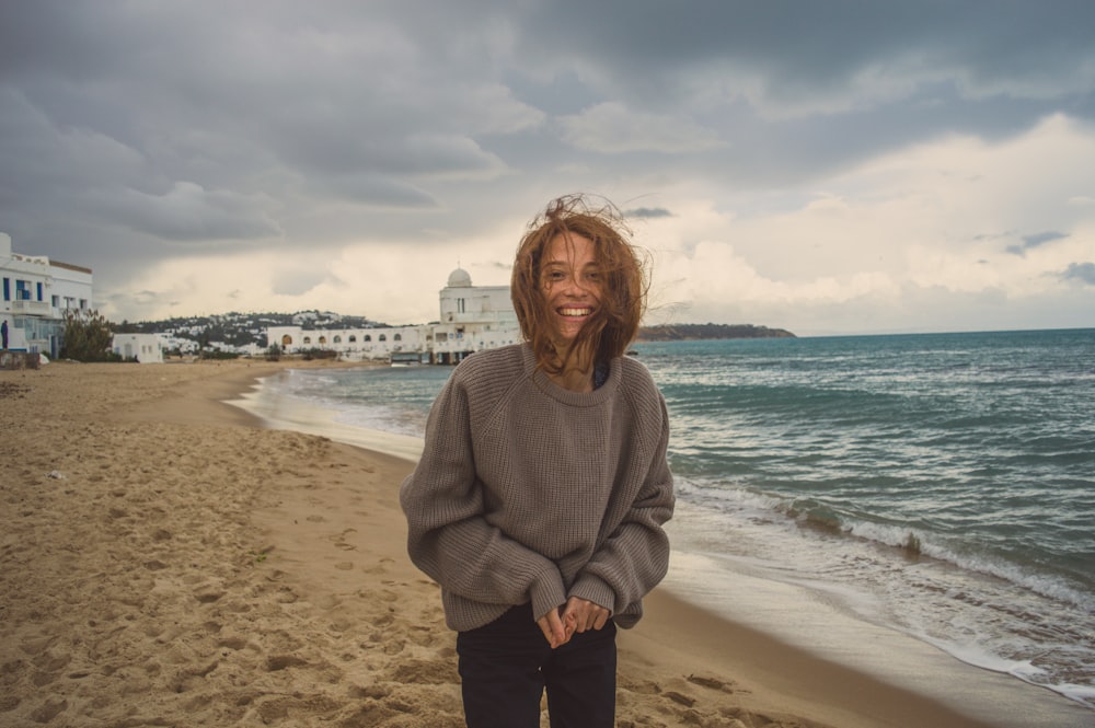 smiling woman wearing grey sweater