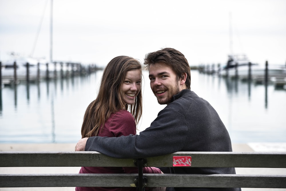 man and woman sitting on a bench photography