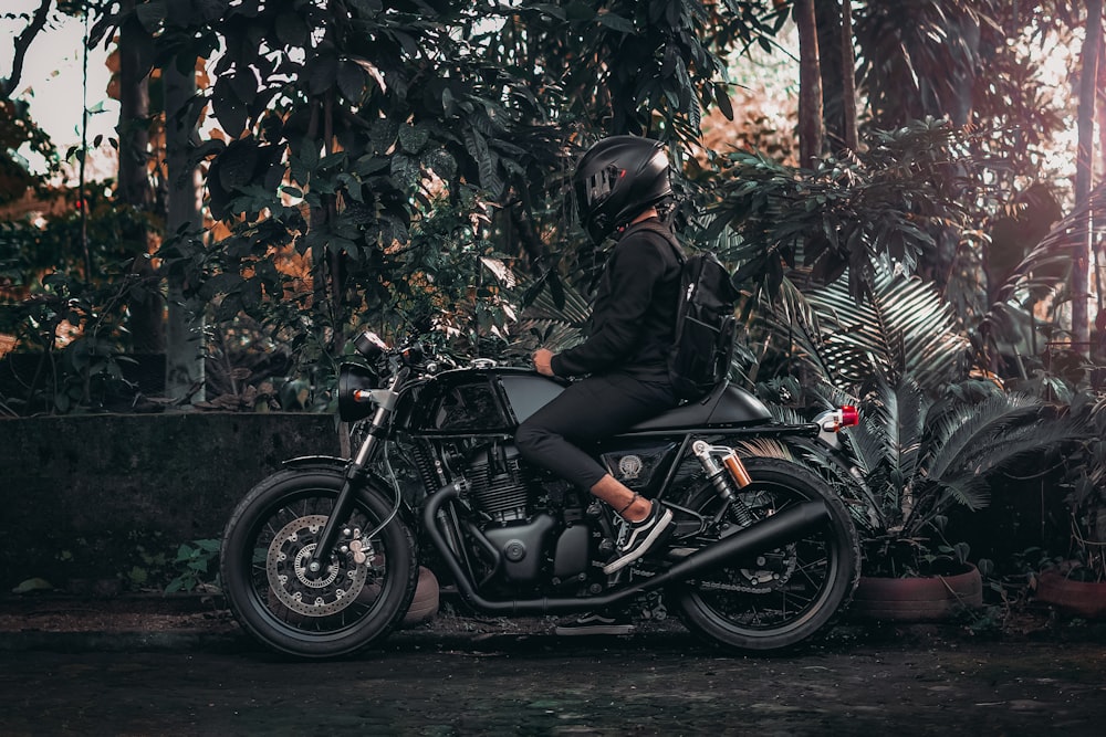 person wearing helmet riding on motorcycle