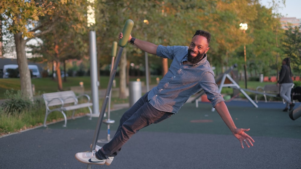 man riding on the silver concrete pot on playground