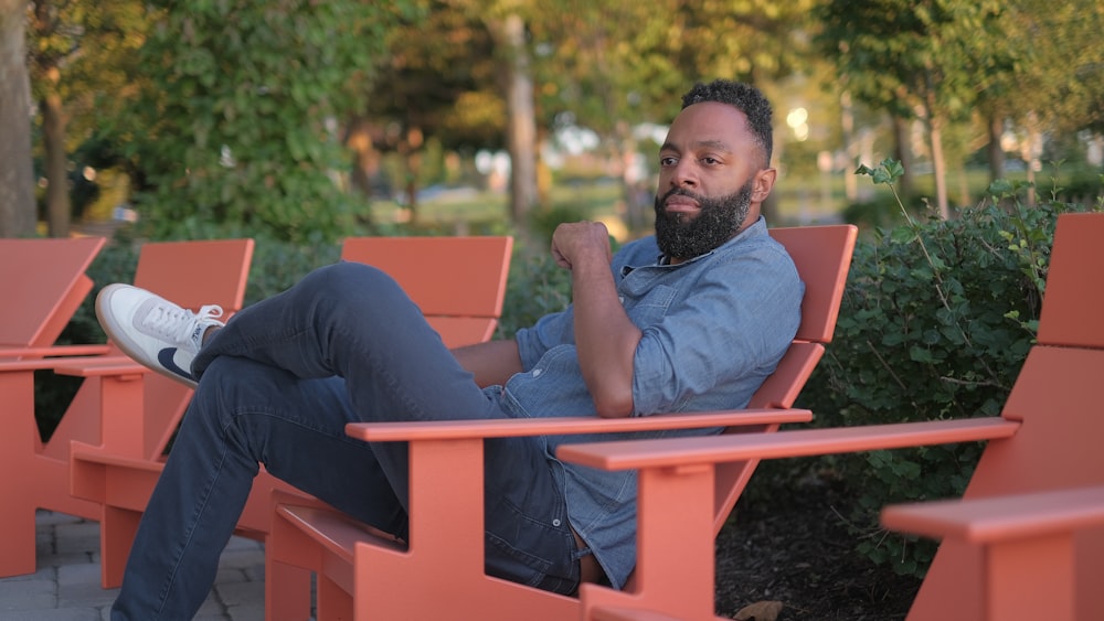 man sitting on red armchair