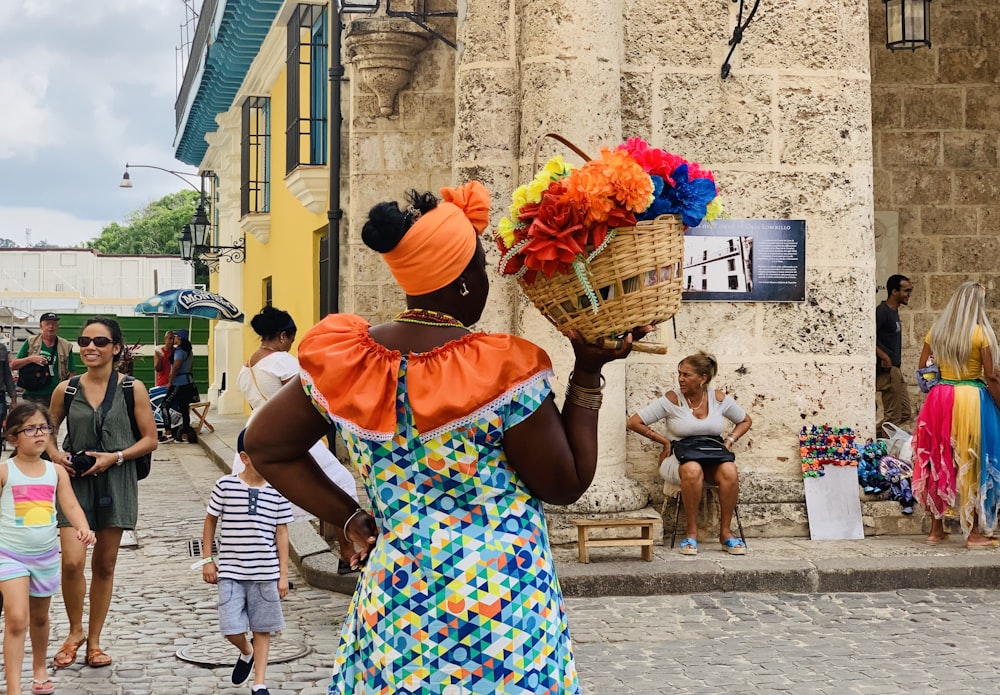 standing woman holding basket of flowers