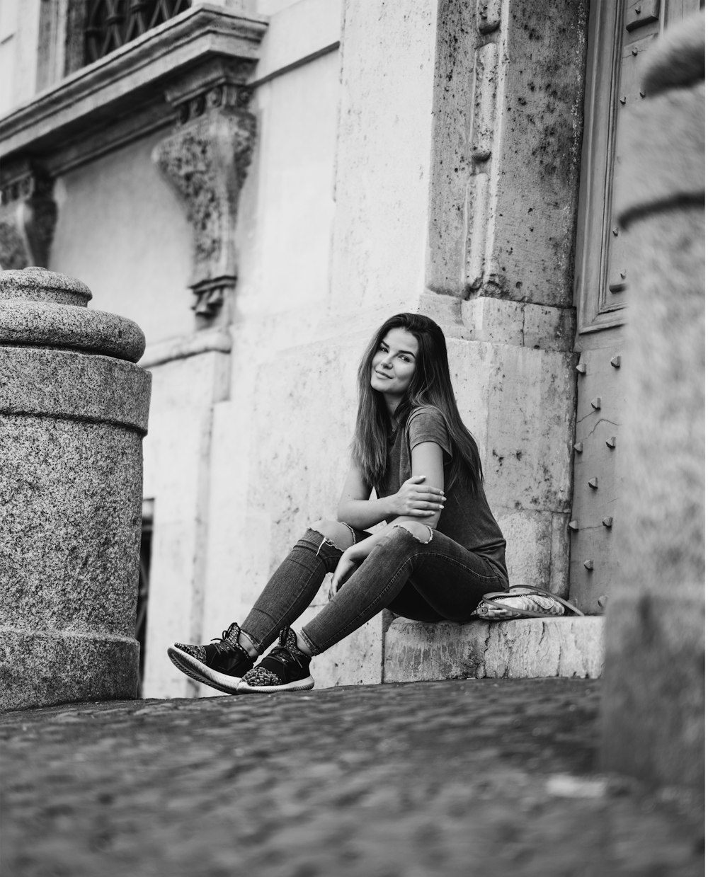 woman sitting on pavement