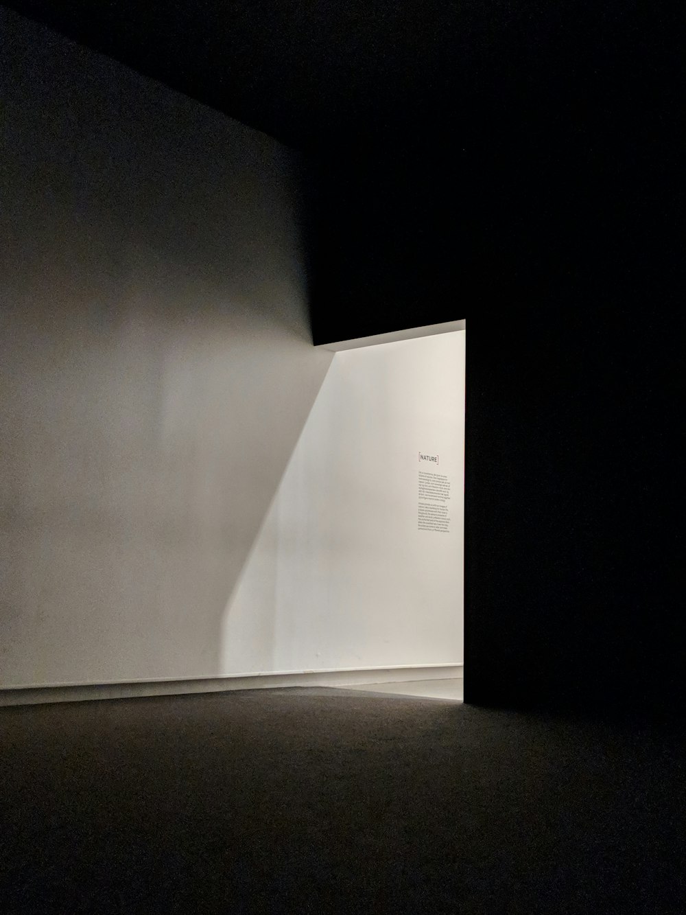 an empty room with a light coming through the wall