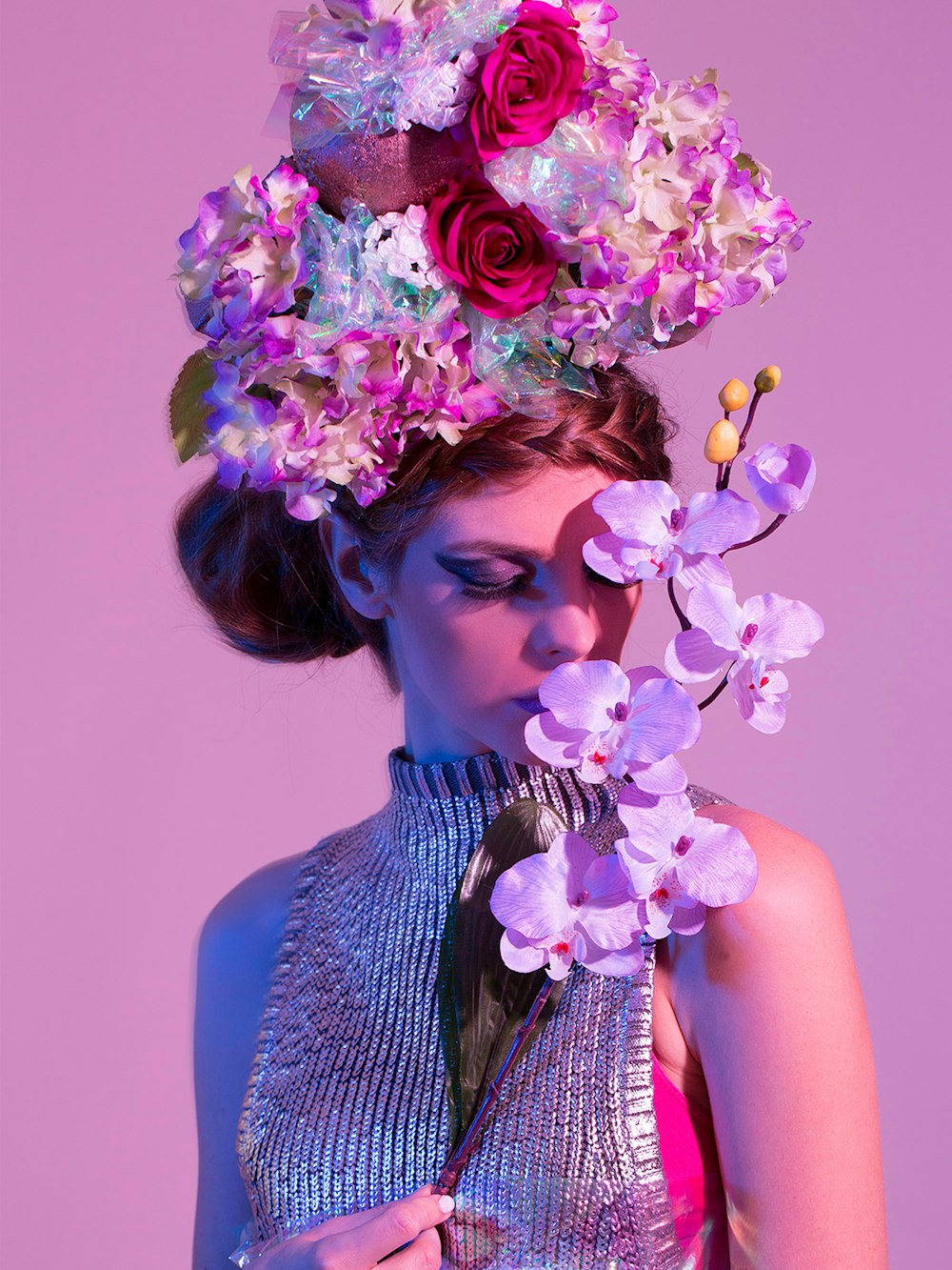 woman holding purple orchid flower