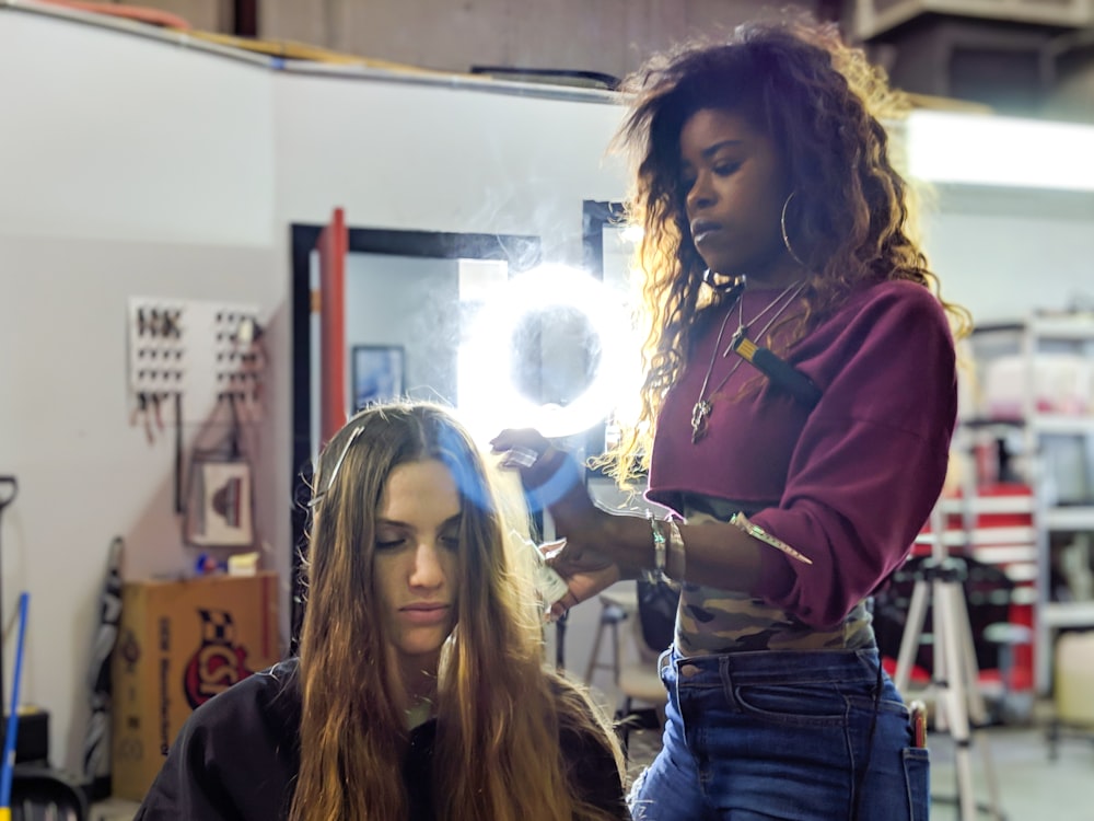 woman fixing woman's hair